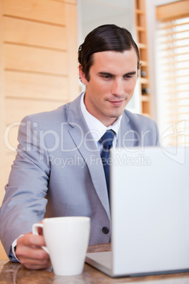 Businessman with laptop and coffee