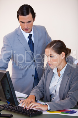 Businesswoman showing screen to her colleague