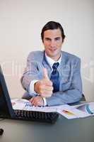 Businessman approves with thumb up