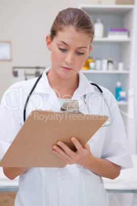 Doctor taking notes on clipboard