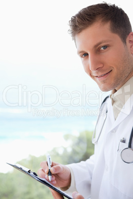 Side view of doctor with clipboard