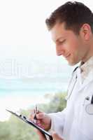 Side view of doctor taking notes
