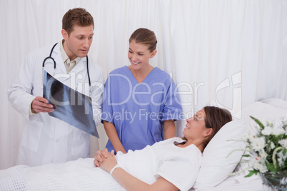 Doctors explaining x-ray to patient