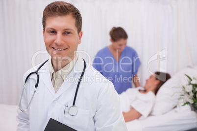 Doctor standing in patients room