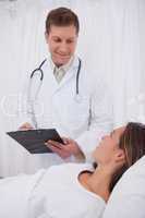 Doctor talking with bedridden patient