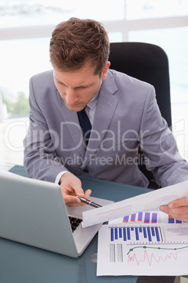 Businessman looking at his laptop