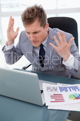 Businessman getting furious over laptop