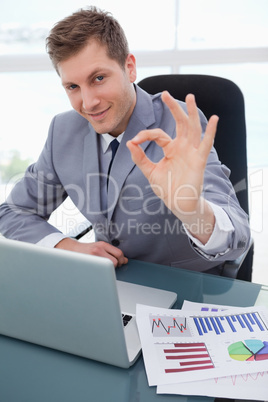 Businessman at his desk giving his approval
