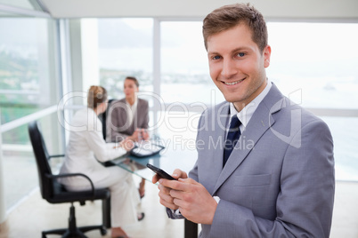 Sales manager holding cellphone
