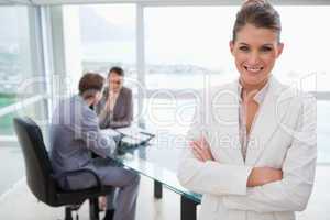 Smiling marketing manager standing in conference room