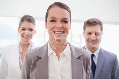 Business consultant with her team behind her