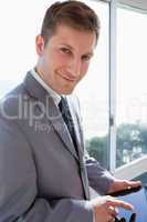 Businessman with his tablet in front of the window