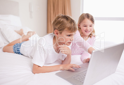 Siblings using a notebook