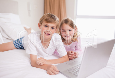 Siblings using a laptop