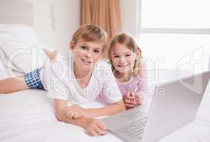 Siblings using a laptop