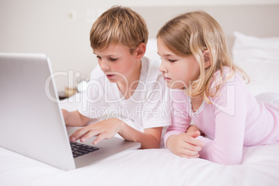 Cute children using a laptop