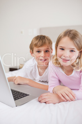 Portrait of cute children using a laptop