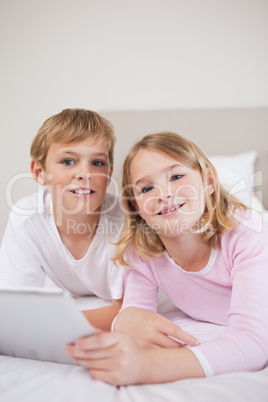 Portrait of children using a tablet computer