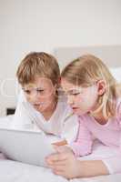 Portrait of cute children using a tablet computer