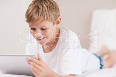 Smiling boy using a tablet computer