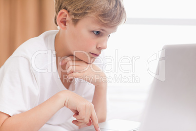 Young boy using a notebook