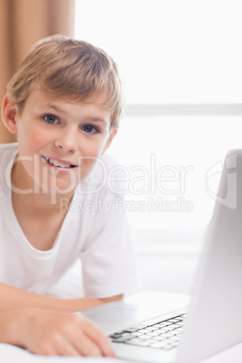 Portrait of a young boy using a laptop