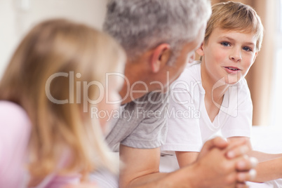 Father having a discussion with his children