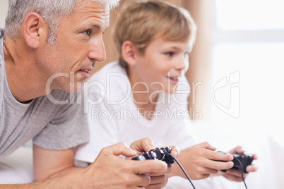 Father playing video games with his young son