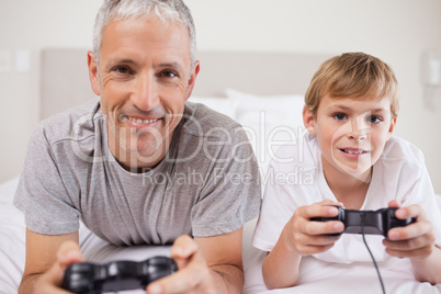 Boy and his father playing video games