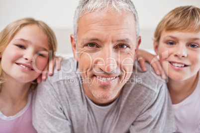 Close up of siblings and their father posing