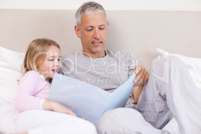 Father reading a story to his daughter