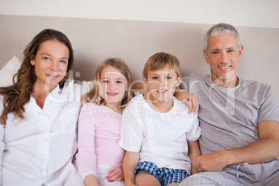 Happy family lying on a bed