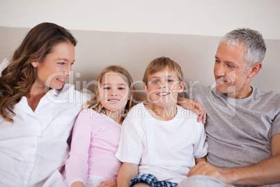 Good looking family lying on a bed
