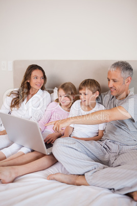 Portrait of a family using a notebook