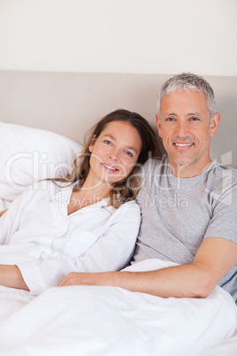 Portrait of a couple lying on a bed