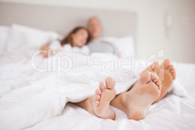 Lovely couple lying in a bed