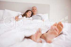 Charming couple lying in a bed