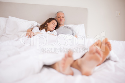 Couple sleeping in their bedroom