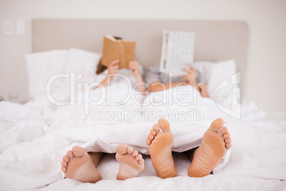 Couple reading while hiding their faces
