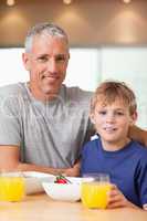 Portrait of a boy and his father having breakfast