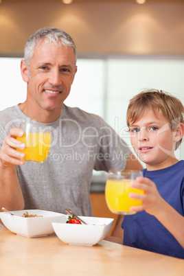 Portrait of a cute boy and his father having breakfast