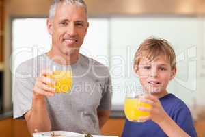Boy and his father having breakfast