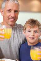 Close up of a boy and his father having breakfast