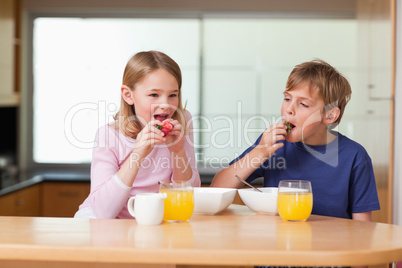 Children eating strawberries for breakfast