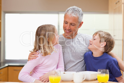 Smiling father with his children in the morning