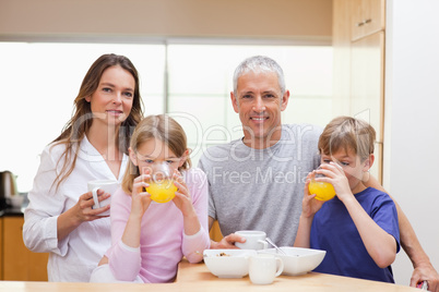 Smiling family having breakfast