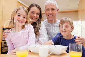 Close up of a smiling family having breakfast