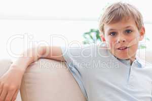 Boy leaning on a sofa