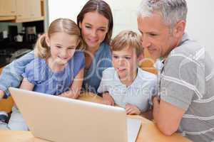 Lovely family using a laptop