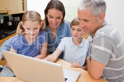 Lovely family using a notebook